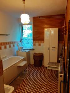 a bathroom with a tub and a toilet and a sink at Zwolaki in Ulanów