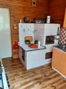 a model of a kitchen with a stove at Zwolaki in Ulanów