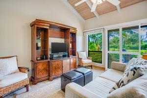 a living room with two couches and a tv at Hale Poipu Nani in Koloa