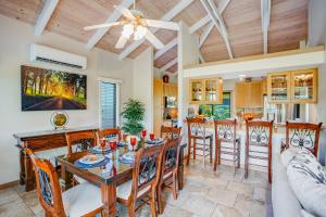 a dining room and kitchen with a table and chairs at Hale Poipu Nani in Koloa