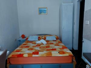 a bedroom with a bed with a colorful comforter at Dalibor in Senj