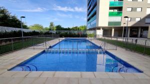 a swimming pool in front of a building at El Balcón del Ebro by Alogest- Vistas, piscina y 2 parking in Zaragoza