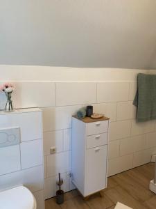 a bathroom with a toilet and a sink at Marlene Ferienwohnung mit Dachterasse ca 50qm in Burg +25 photos