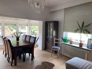 a dining room with a table and chairs and a room at Marlene Ferienwohnung mit Dachterasse ca 50qm in Burg
