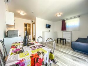 a kitchen and a dining room with a table at FeDa Apartmanház in Balatonboglár