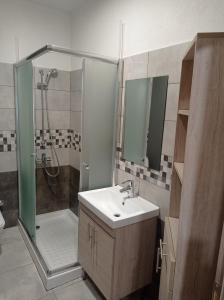 y baño con ducha, lavamanos y ducha. en Nikos & Patras Houses, en Nea Plagia