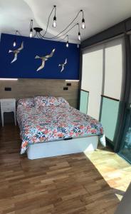 a bedroom with a bed with birds on the wall at Apartamento Rosario 2 in Vigo