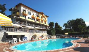 a large swimming pool in front of a hotel at Hotel La Bussola in Orta San Giulio