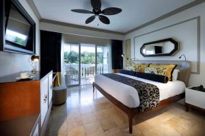 a bedroom with a king sized bed and a balcony at Grand Palladium Lady Hamilton Resort & Spa - All Inclusive in Lucea