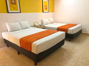 Postel nebo postele na pokoji v ubytování Hotel Los Cocos Chetumal