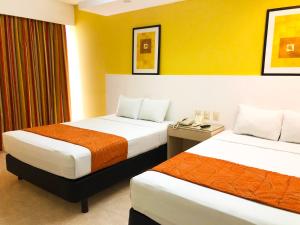Postel nebo postele na pokoji v ubytování Hotel Los Cocos Chetumal