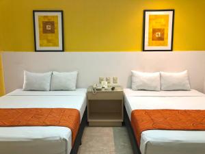 Postel nebo postele na pokoji v ubytování Hotel Los Cocos Chetumal