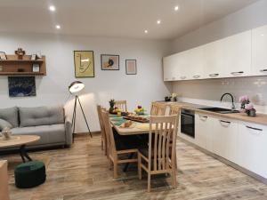 a kitchen and living room with a table and a couch at Apartmani Tripalo in Imotski