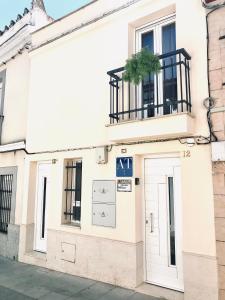 a white building with a door and a window at Apartamentos Élite - Art Collection - Frida in Mérida +52 photos