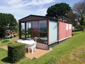 a tiny house with a large window and a picnic table at Bungalow in Laredo