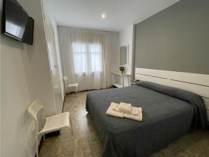 Posteľ alebo postele v izbe v ubytovaní Hostal Mediterráneo