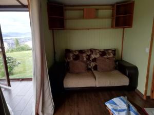 a couch sitting in a room with a window at Bungalow in Laredo