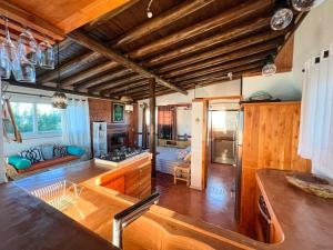 a large kitchen with wooden floors and wooden ceilings at Stupa Eco Vila in Barra de Ibiraquera