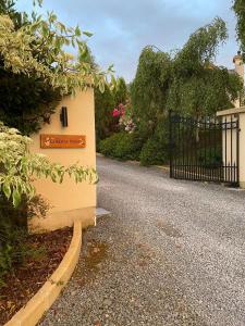 a driveway with a gate and a sign on a house at Corness House B&B in Monaghan