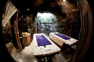 a room with two beds in a cave at Royal Muang Samui Villas in Choeng Mon Beach