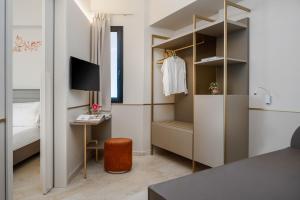 a small room with a bed and a desk and a bedroom at Hotel Imperiale Rimini & SPA in Rimini