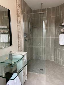 a bathroom with a glass sink and a shower at Corness House B&B in Monaghan