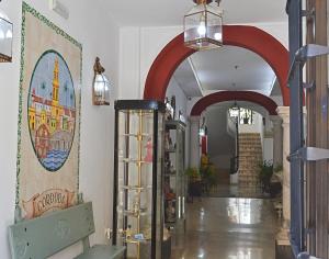 a hallway with red arches in a store at Hotel Marisa in Córdoba