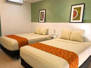 Postel nebo postele na pokoji v ubytování Hotel Los Cocos Chetumal