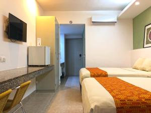 Cama o camas de una habitación en Hotel Los Cocos Chetumal
