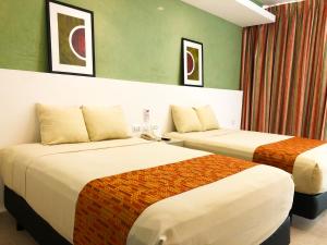 Postel nebo postele na pokoji v ubytování Hotel Los Cocos Chetumal