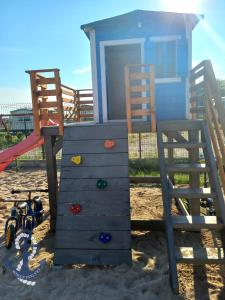 a playground with two chairs and a play house at Morska Enklawa in Gąski