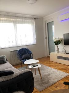 a living room with a couch and a table at Apartman ML in Lukavica