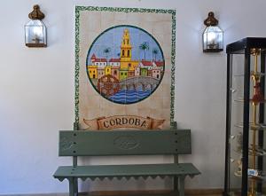 a bench in a room with a painting on the wall at Hotel Marisa in Córdoba +86 photos