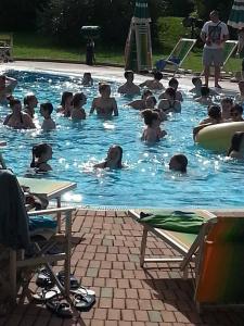 a group of people in a swimming pool at Hotel Ala Bianca in Ameglia