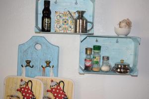 a wall with two shelves with bottles on it at Sa Domitta di Suiles in Olbia