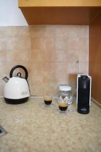 a kitchen counter with two cups of coffee and a toaster at Daniel's garden apartment in Eilat