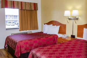 a hotel room with two beds and a window at Econo Lodge East in Albuquerque
