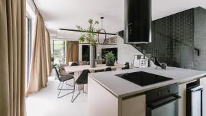 a kitchen and dining room with a table and chairs at Villa Domina by Villas Holiday in Srima