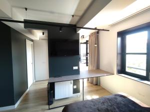 a living room with a large flat screen tv at Apartamentos Puerta de Llanes in Llanes