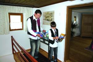 a man and a young boy looking at a book at Romantikhäuschen zum Dachsteinblick in Abtenau +45 photos