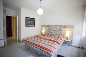 a bedroom with a bed and a brick wall at Apartment Red in Belgrade