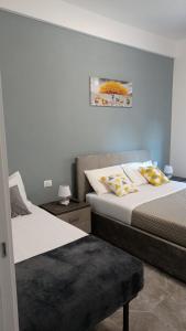 a bedroom with two beds and a picture on the wall at Adelina House in La Spezia