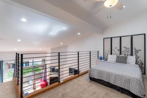 a bedroom with a bed and a large window at Franklin Hollywood Bowl Loft in Los Angeles