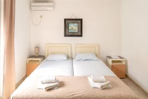 a white bedroom with two beds with towels on them at Guest House Jasna in Budva +61 photos