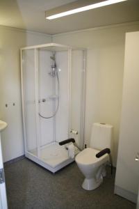 a bathroom with a shower and a toilet at Flekkerøy 20 persons in Kristiansand