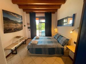 a bedroom with a bed and a window at La FIOCCHINA - Magic Place - apartments & studios in Garda Lake - countryside farmhouse, inside the middle of the lake between sky & water in Salò