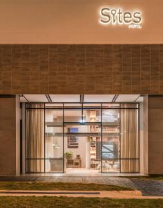 a facade of a building with the entrance to a store at Hotel Sites Barranquilla in Barranquilla