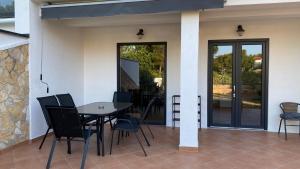 a dining area with a table and chairs on a patio at VILLA HOLIDAY in Banjole