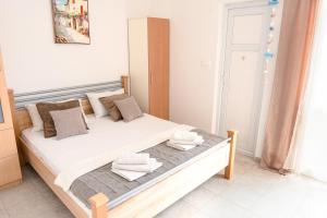 a bedroom with a bed with two towels on it at Guest House Jasna in Budva