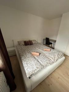 a bedroom with a white bed with two pillows at Apartma Bohinj in Bohinj